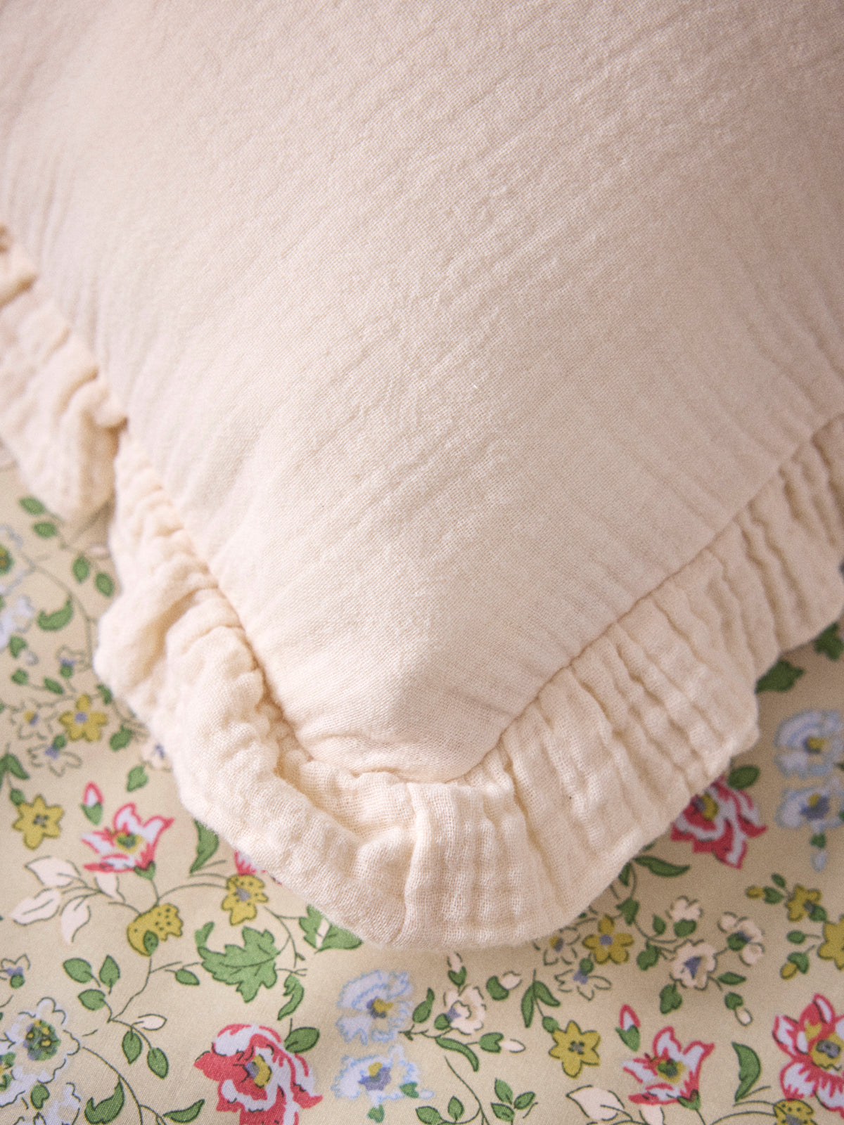 Ruffled gauze pillow with gold embroidery