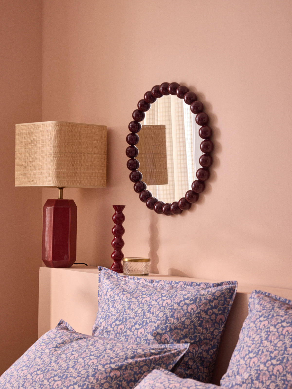 Round mirror trimmed with wooden balls