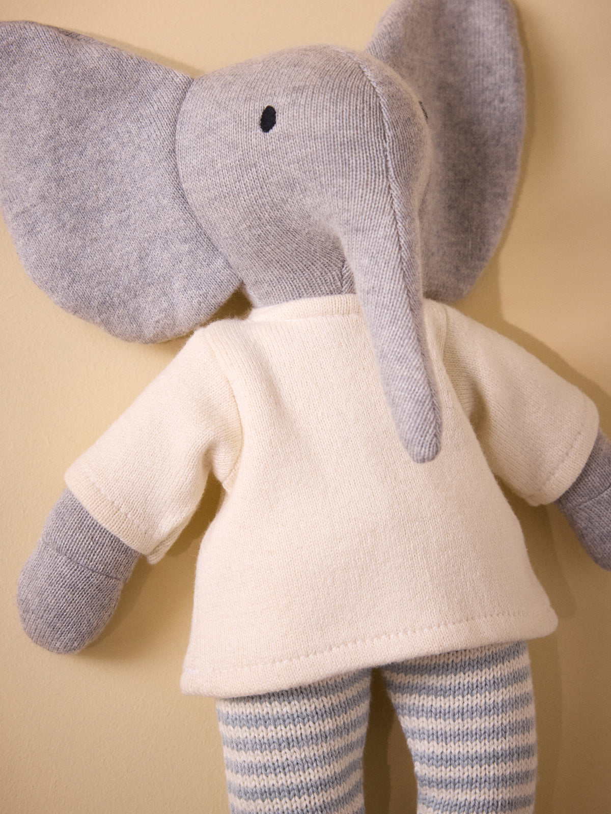 Knit elephant plush toy in a garter-stitch outfit